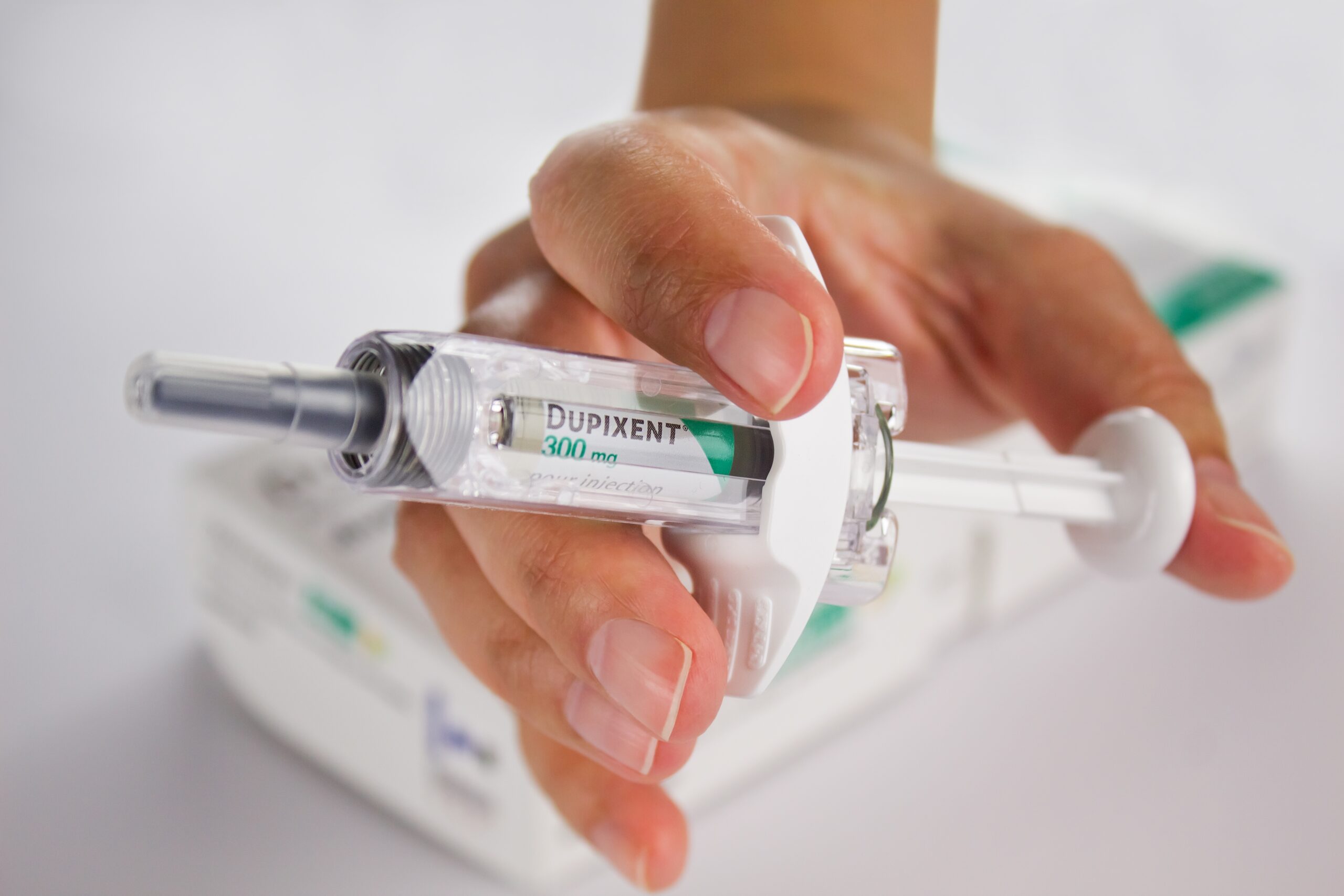 Hand holding a dupixent Injection